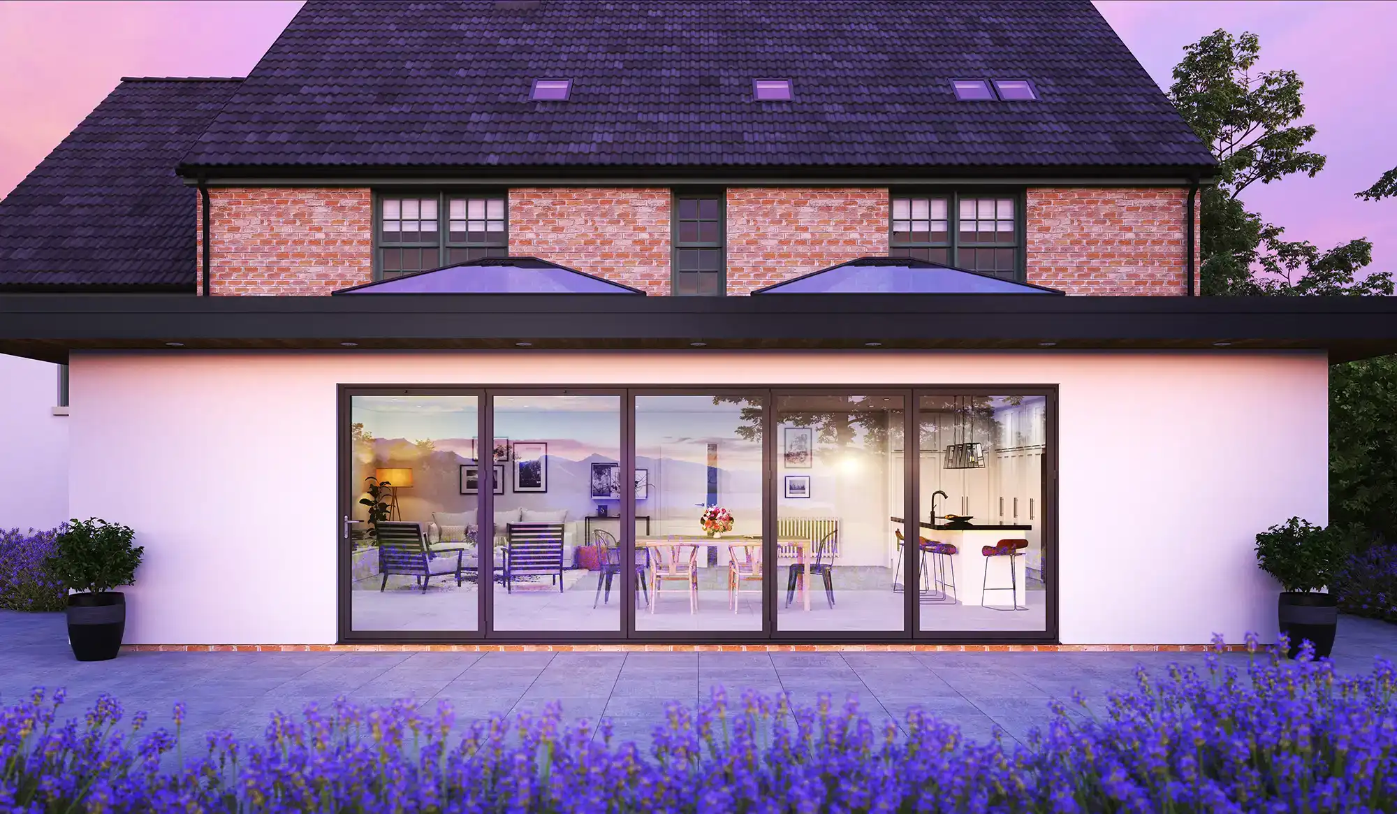 Modern home exterior with sliding glass doors, colorful outdoor furniture, and lavender flowers in the foreground at sunset.