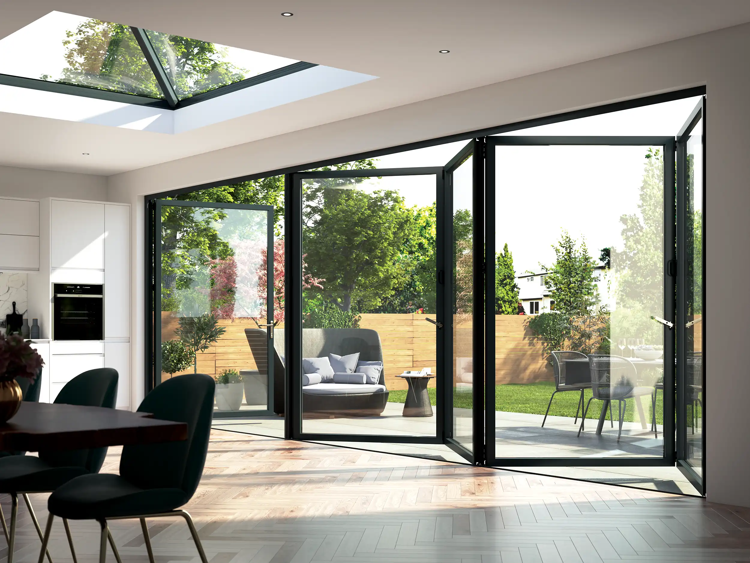 Modern living room with large bifold doors opening to a garden, featuring greenery and patio furniture, and a skylight above.